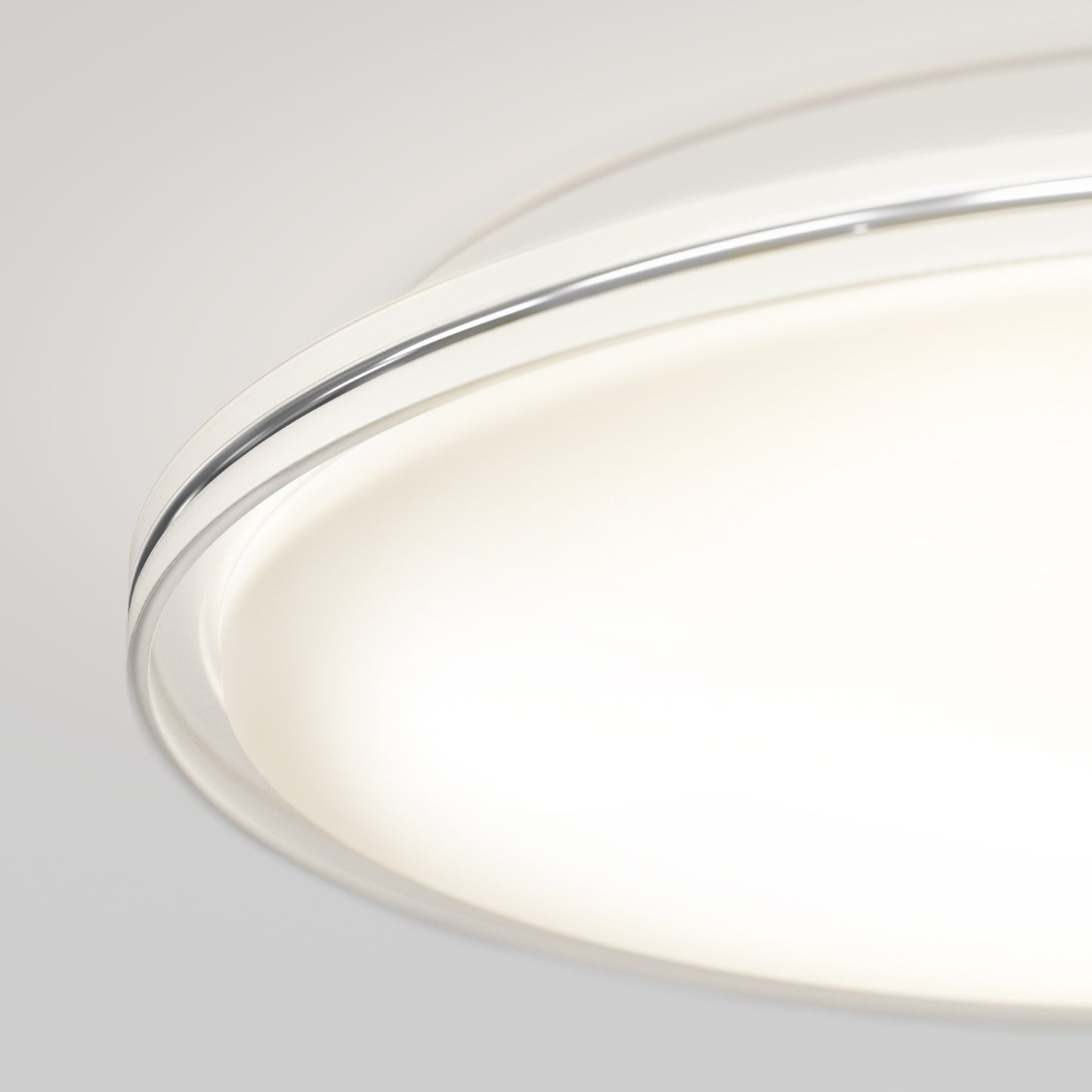 Close-up of the Artika Astrid 16.5 in. LED flush mount light with 5 CCT and remote, featuring a modern circular design, metallic rim, and soft white illumination against a plain background.