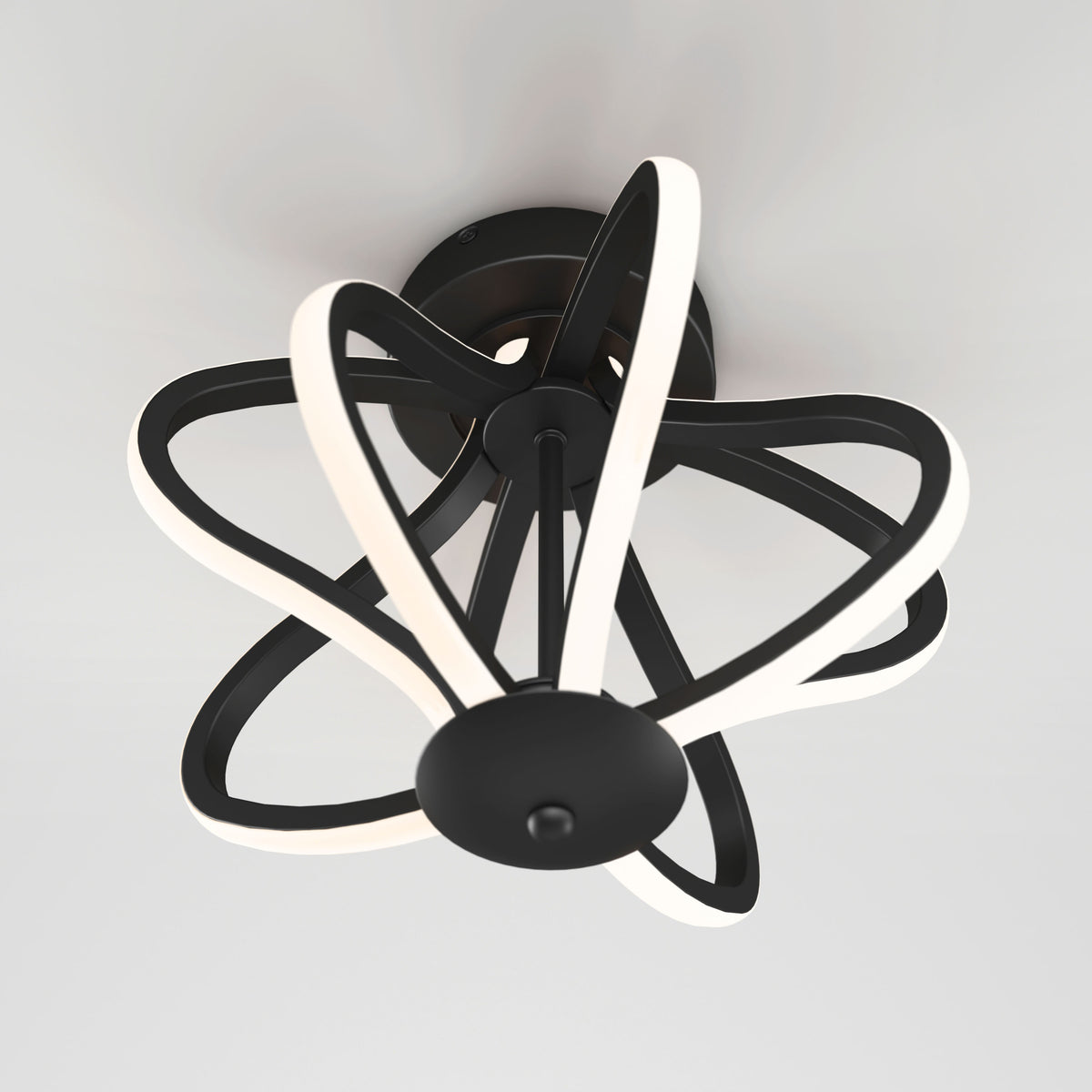 A modern ceiling light fixture with black curving arms and integrated white LED strips, forming an abstract, flowing design against a white ceiling.