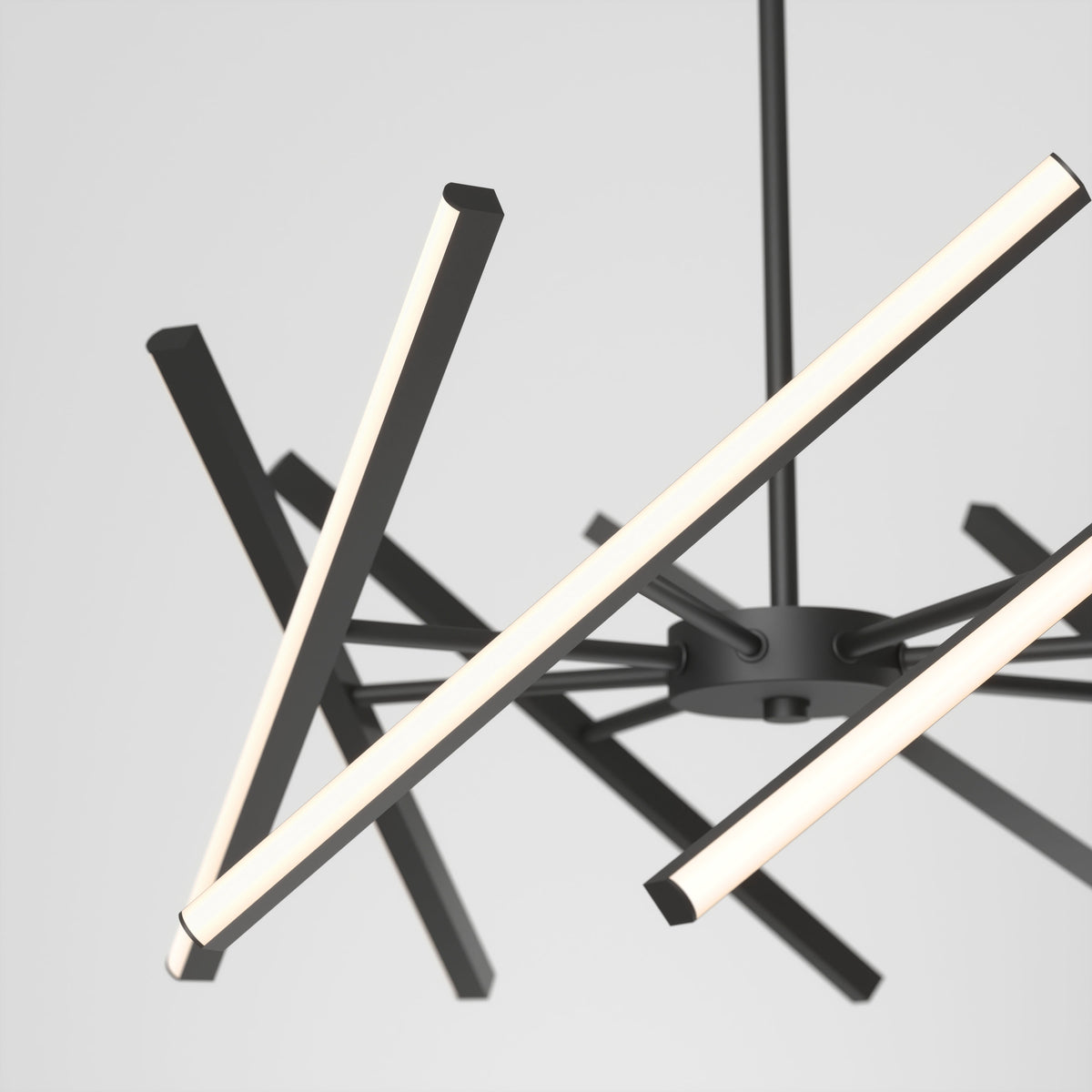 Modern chandelier with multiple intersecting, black metal arms, each featuring linear LED lights, suspended from a central rod against a plain white background.