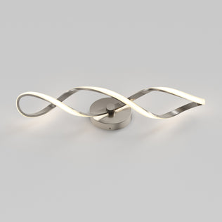 The Artika Swirl LED bathroom vanity light features two intertwined wavy metallic arms, with one arm emitting a soft white glow, displayed against a plain light gray background.
