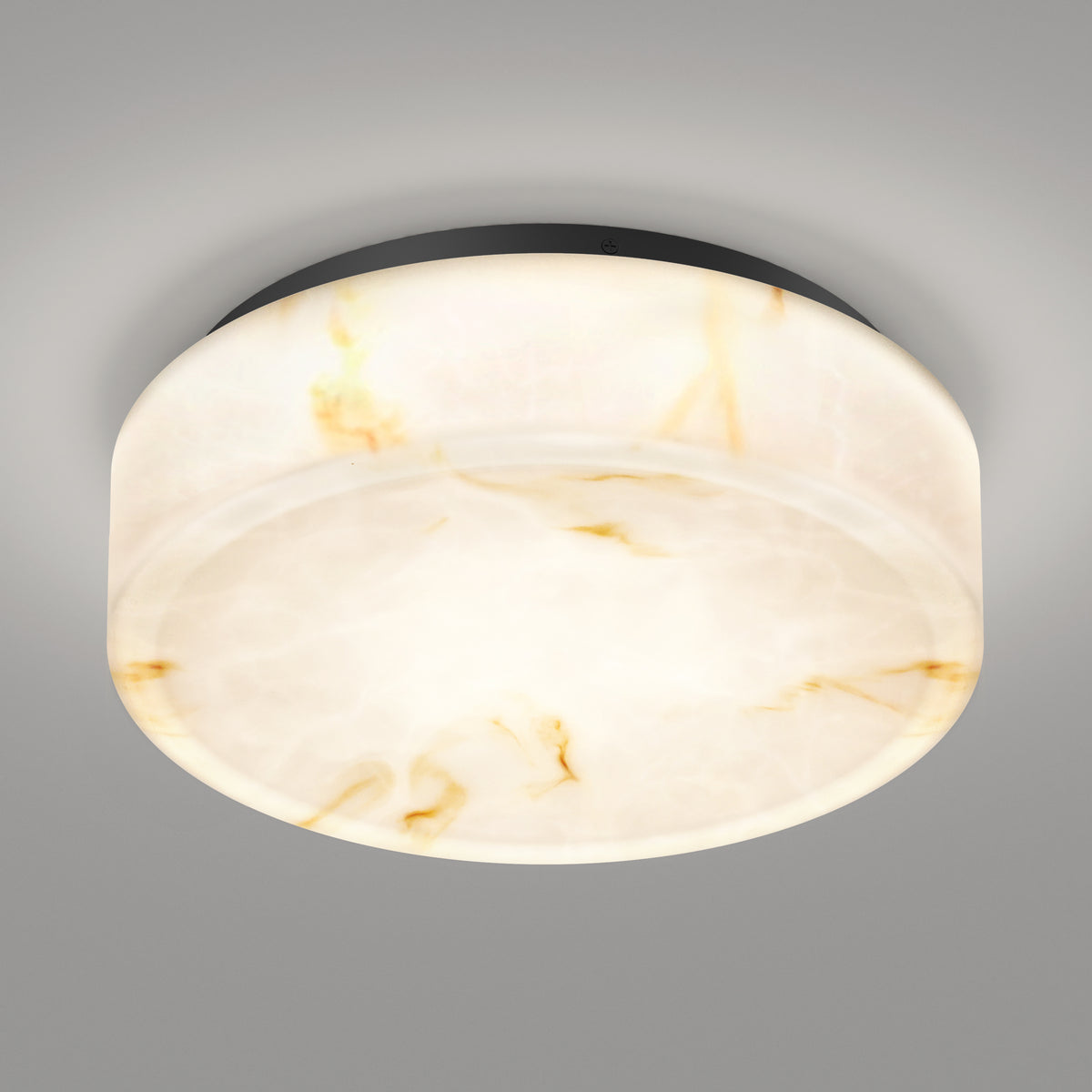 A round, flush-mount ceiling light with a marble-like, translucent white and beige shade is illuminated against a plain, light gray ceiling.