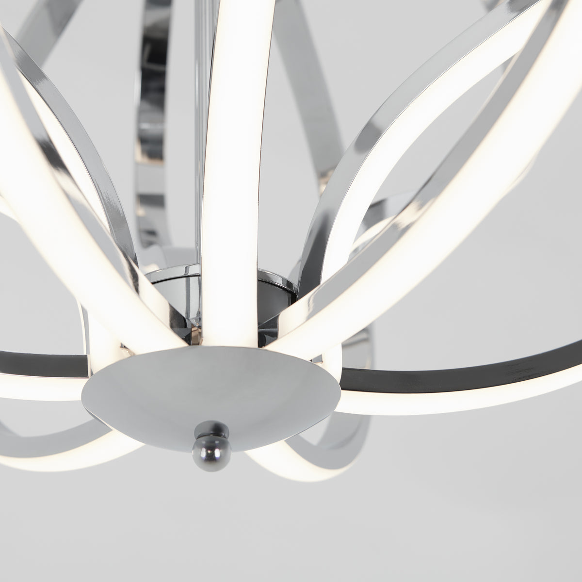 Close-up of the Artika Meridian LED pendant light, featuring curved chrome-finished arms and integrated LED strips, set against a white background—a striking piece of contemporary lighting.