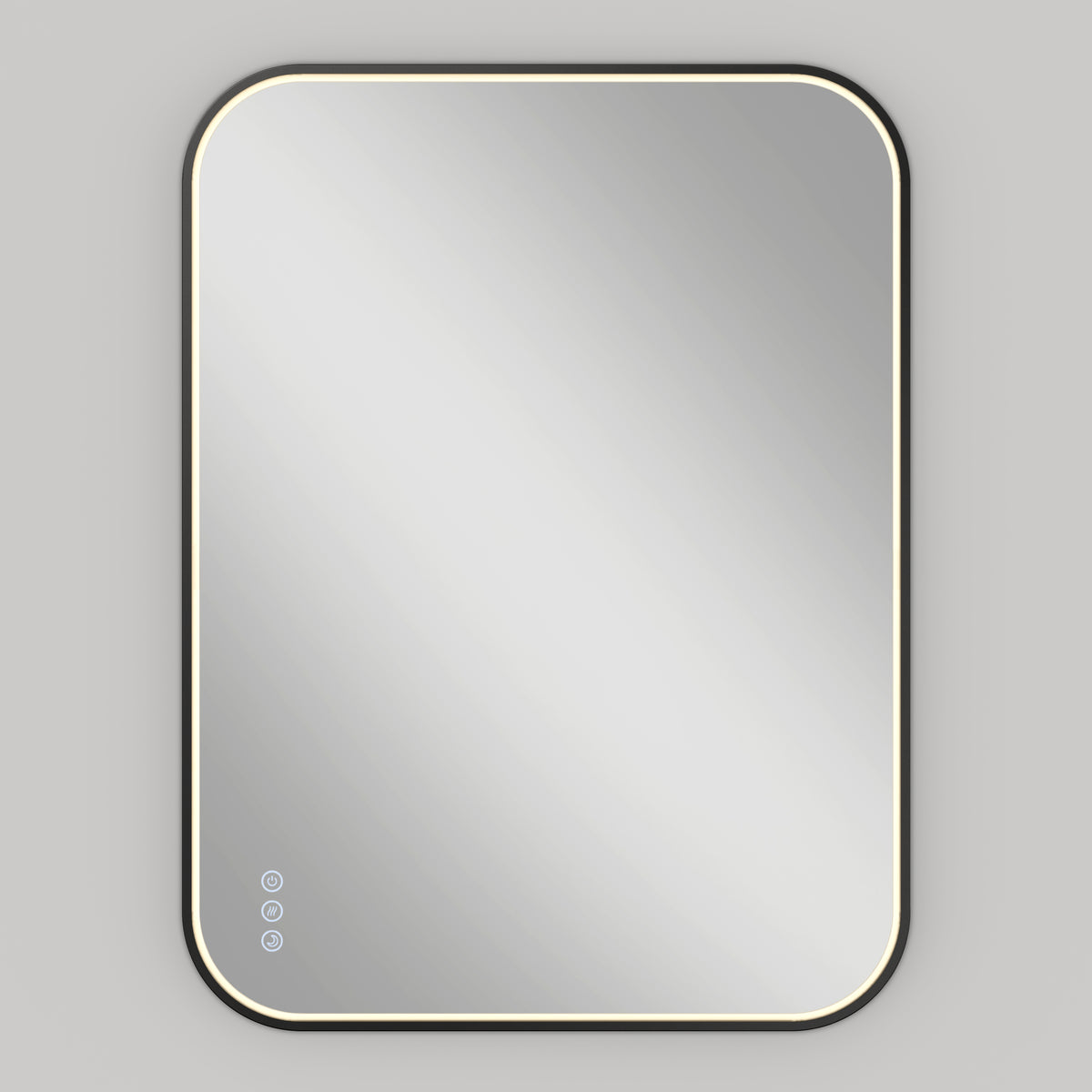 A rectangular wall-mounted mirror with rounded corners, illuminated by a soft LED light around its edges, and three touch control buttons in the lower left corner, set against a plain light gray background.