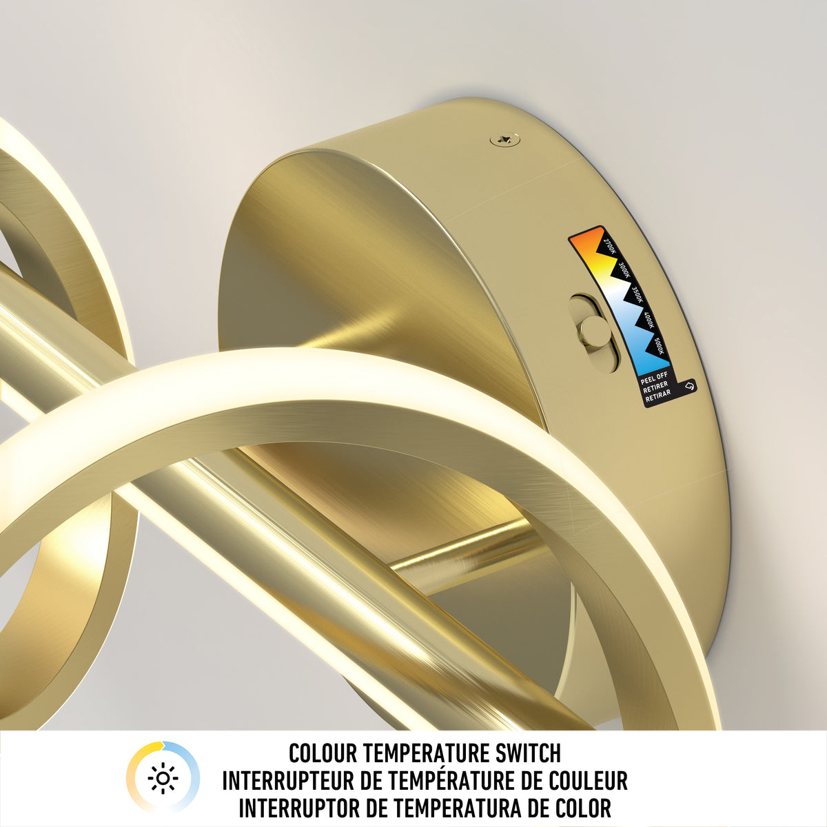 Gold light fixture with circular LED rings mounted on the wall. A color temperature switch is visible, showing a range from warm to cool light. Text below indicates “COLOUR TEMPERATURE SWITCH” in three languages.