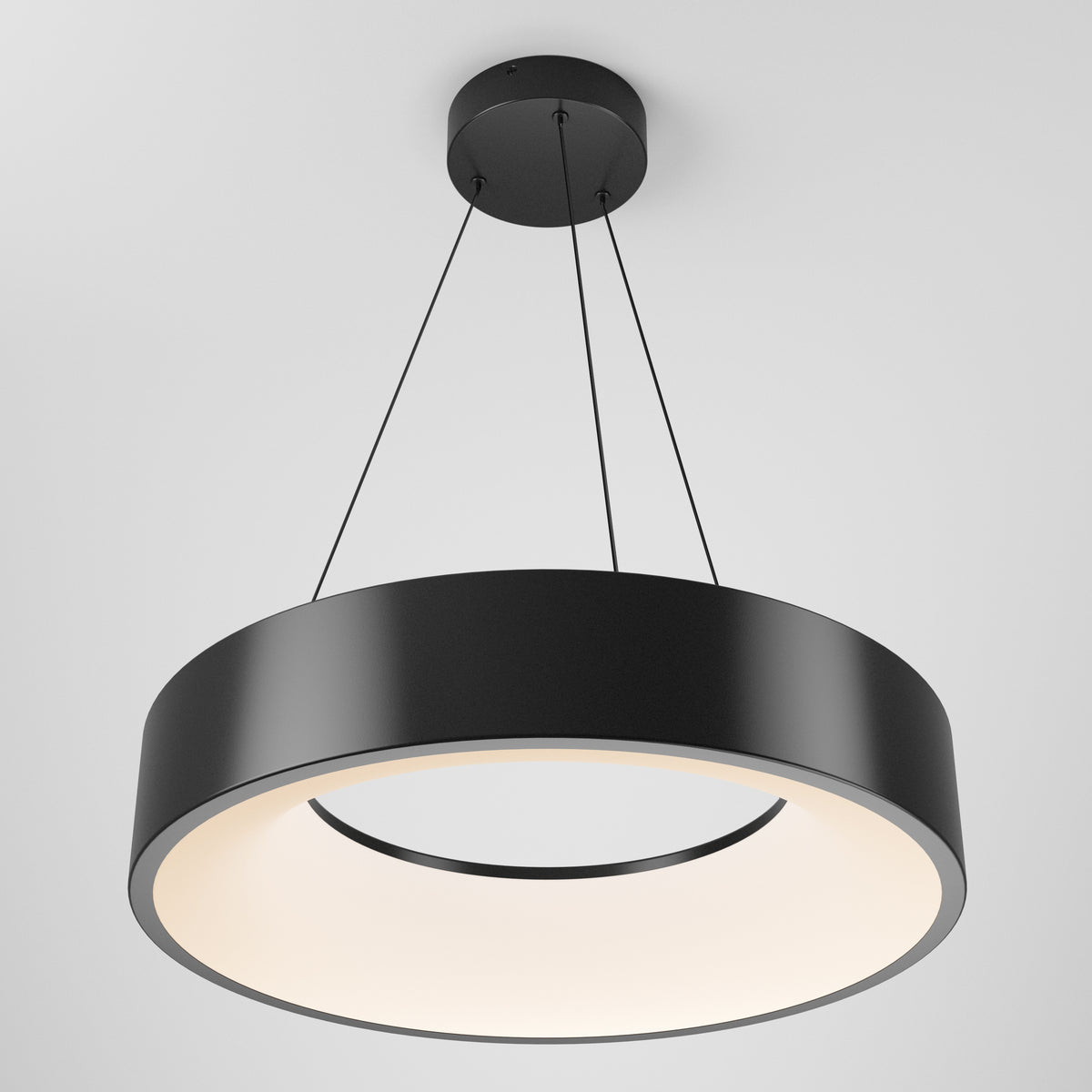 The Aiden LED pendant light by Artika features a modern black circular design suspended by three cables, with a wide ring shape and soft, diffused white illumination from within.