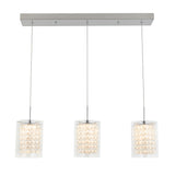 Three modern pendant lights with square, clear glass shades hang in a row from a rectangular metal ceiling mount. Each shade contains a cluster of sparkling crystal-like elements.