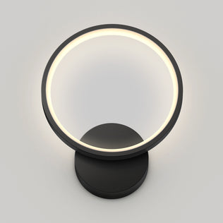 The Artika Solis modern LED indoor-outdoor wall light 5 CCT features a circular glowing ring on a round black base, displayed against a plain light gray background.