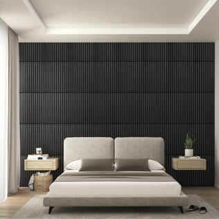 A modern bedroom features a light gray upholstered bed, two floating wooden nightstands, an Artika Sonolok 15.5 ft sound-absorbing wall panel kit as the dark accent wall behind the bed, and a large window with sheer white curtains on the left.