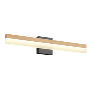 The Artika Neil modern LED bathroom vanity light features a long, rectangular wooden frame, a frosted light panel, and a black rectangular wall-mounted base.