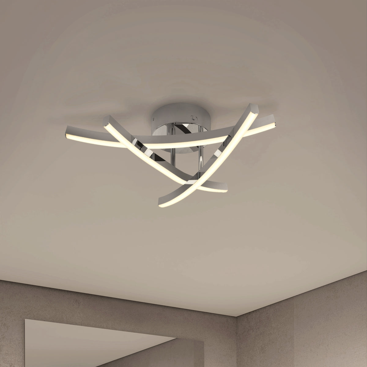 Modern ceiling light fixture with three curved, intersecting LED bars attached to a round chrome base, mounted on a smooth white ceiling in a minimalist room with neutral-colored walls.