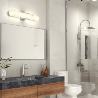 Modern bathroom with black marble countertop, wood vanity, glass shower, wall mirror, and Artika Selena LED bathroom vanity light above.