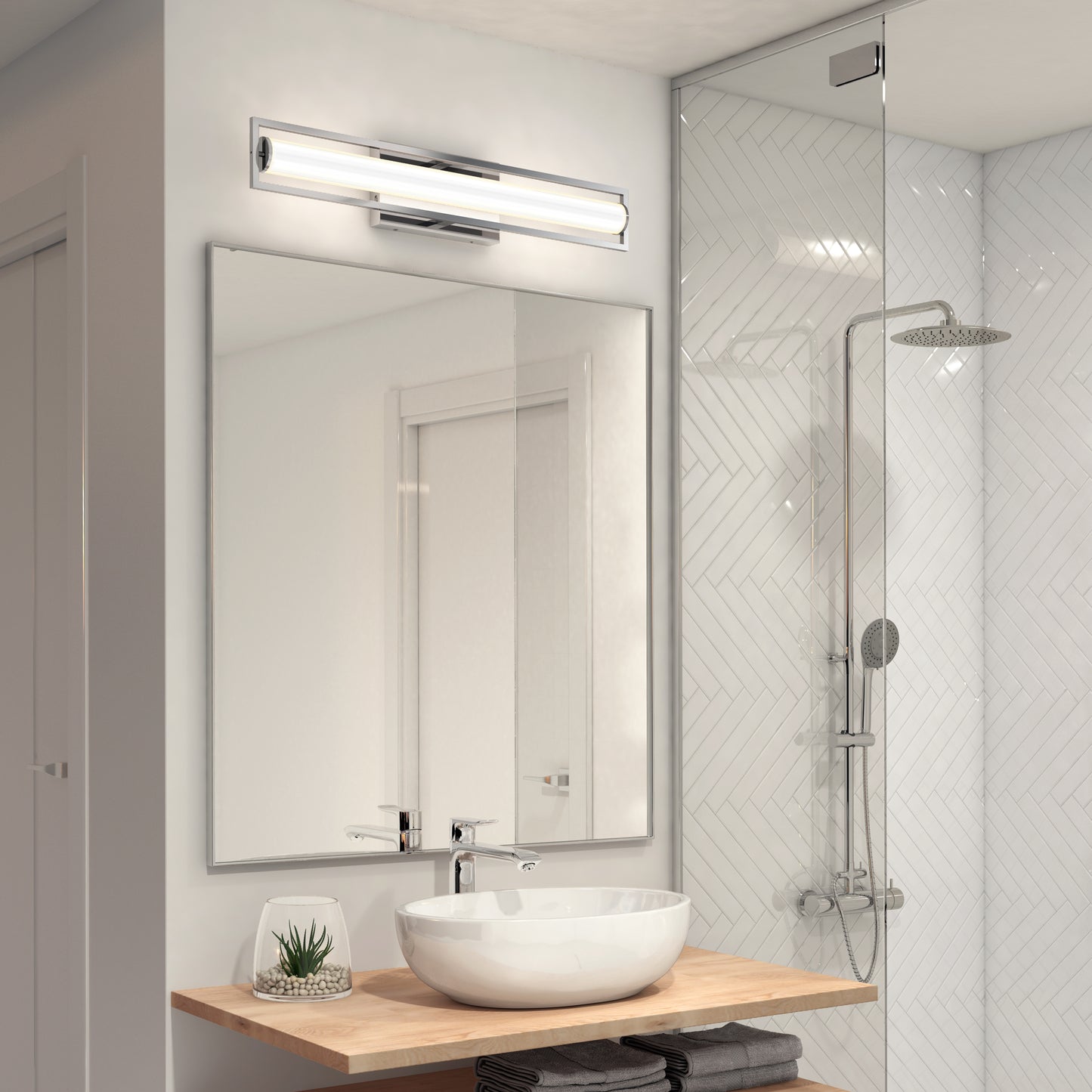 A modern bathroom with a large mirror, round vessel sink on a wooden countertop, small potted plant, glass shower with rainfall showerhead, and the Artika Rialto modern LED bathroom vanity light 3 CCT above the mirror.