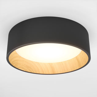 The Artika Alton LED flush mount features a dimmable design with a black outer rim, wooden inner lining, and bright white LED center—ideal for stylish, contemporary spaces.