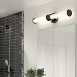 A modern bathroom light fixture with two tubular bulbs mounted horizontally above a large mirror, next to a tiled shower area and a small green plant on the counter.