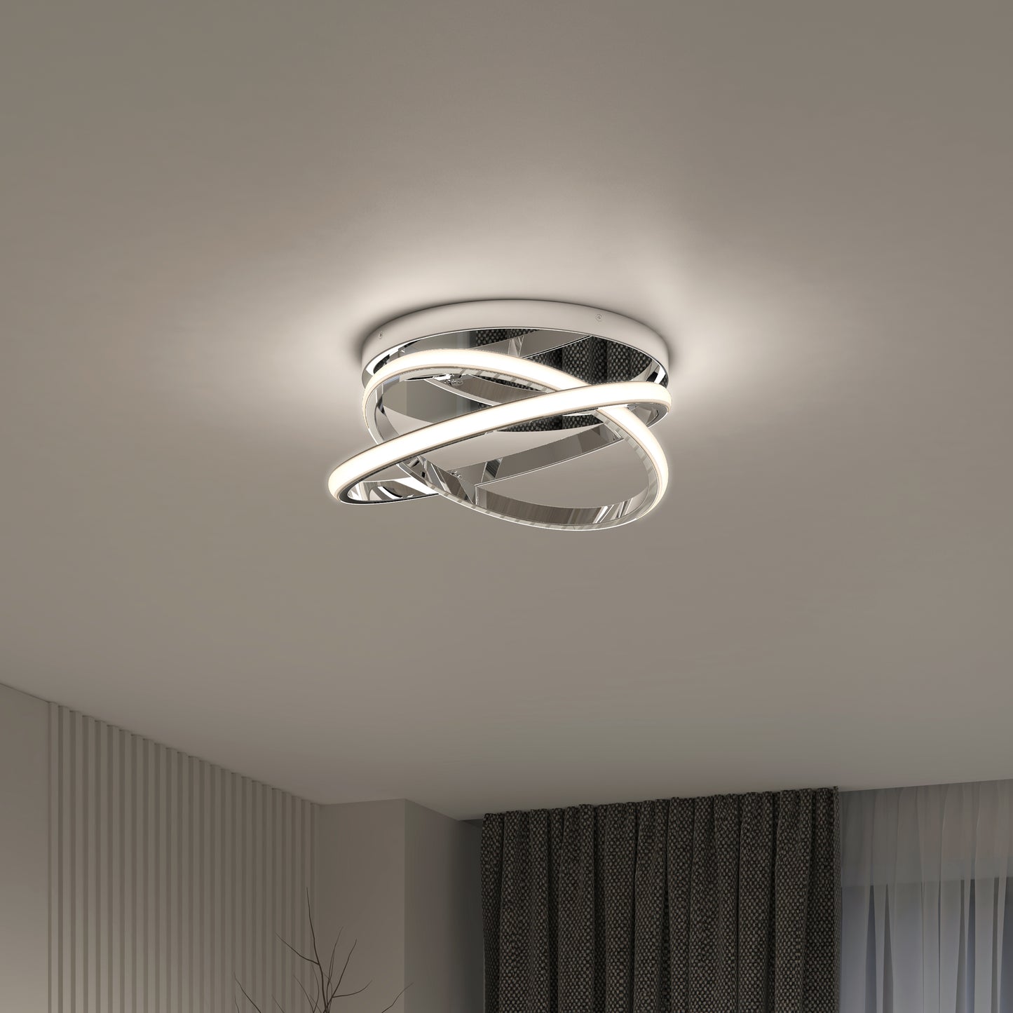 The Artika Orbia modern LED flush mount light 3 CCT, featuring intertwined glowing loops, is mounted on a smooth white ceiling in a room with dark curtains and light-colored walls.