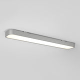 A modern, rectangular LED ceiling light fixture with a sleek silver frame is mounted on a white ceiling, emitting a bright, even glow.