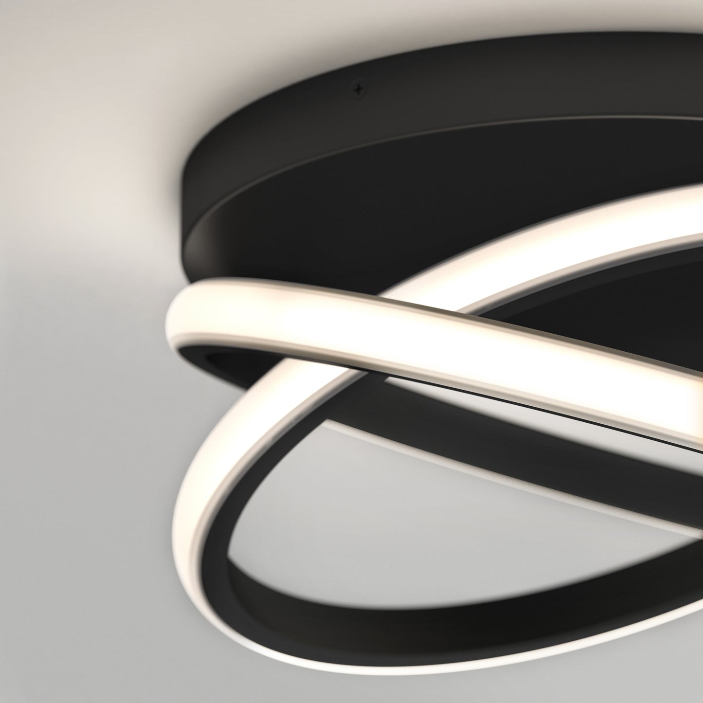 The Artika Orbia modern LED flush mount light features two intersecting circular LED rings on a black base, mounted on a white ceiling. This stylish fixture offers 3 CCT options for customizable lighting.