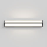A rectangular, wall-mounted light fixture with a minimalist design, emitting a soft white glow, set against a plain light gray background.