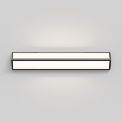 The Artika Preston LED modern bathroom vanity light 3 CCT features a sleek black frame and frosted white diffuser, mounted on a light gray wall and casting a soft, even glow.