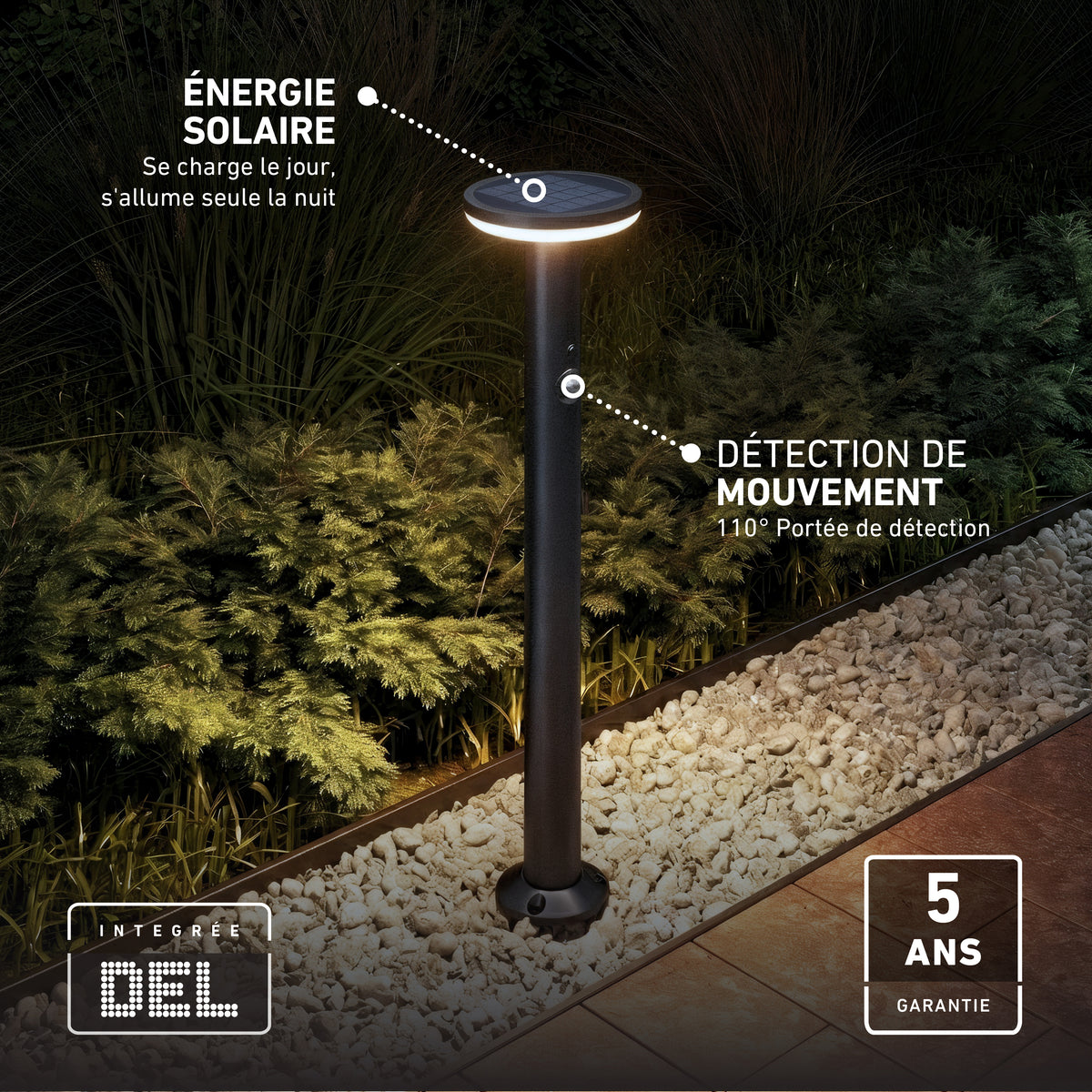 Artika’s Urbia Solar LED Bollard with Motion Sensor stands on gravel, displaying French features and a 5-year warranty near plants.