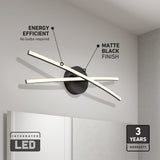 Modern wall-mounted LED light fixture with two intersecting light bars above a mirror, featuring a matte black finish. Text highlights its energy efficiency, integrated LED, and a 3-year warranty.