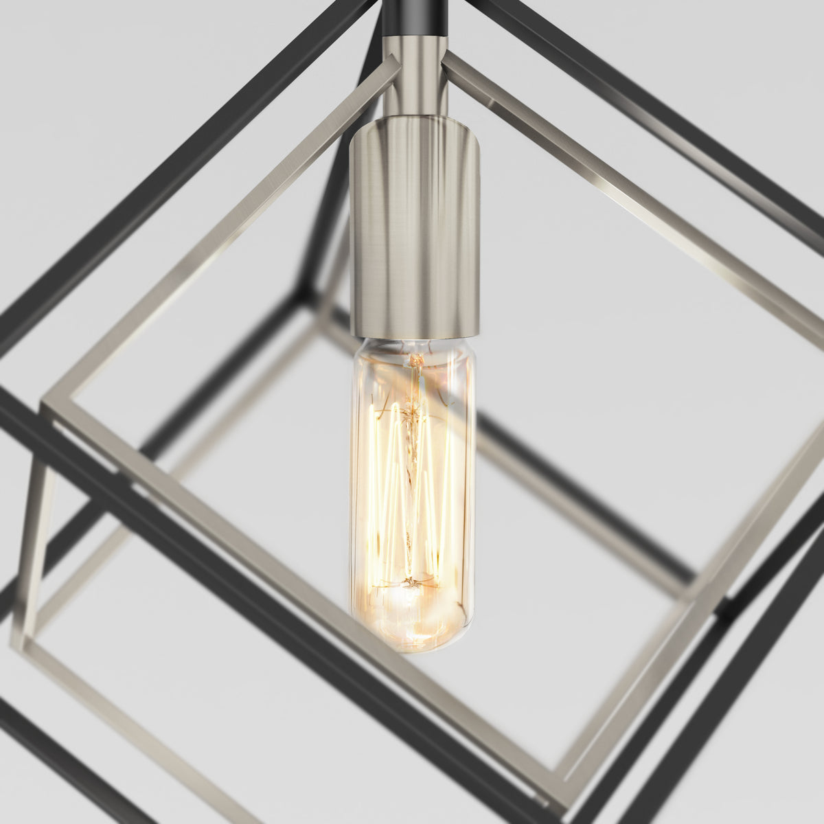 The Artika Imperium Single pendant light features a glowing vintage-style Edison bulb inside a modern, minimalist geometric metallic cube, shown against a plain background.
