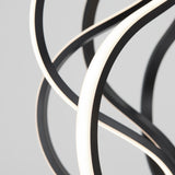Close-up of intertwined, curved black and white LED light strips against a plain, light gray background. The design is abstract and modern, with smooth lines and a glowing effect.