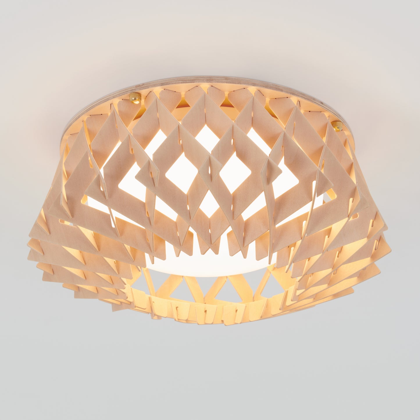 The Artika Kiran 13 in. modern LED flush mount light features a geometric wooden lattice shade that softly diffuses light, adding a warm, modern touch to any white ceiling with its 5 CCT adjustable settings.