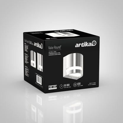 A black and gray Artika Valor Round LED indoor-outdoor wall light box displays product images, specs, and branding, highlighting a 50,000-hour LED lifespan and 830 lumens brightness.