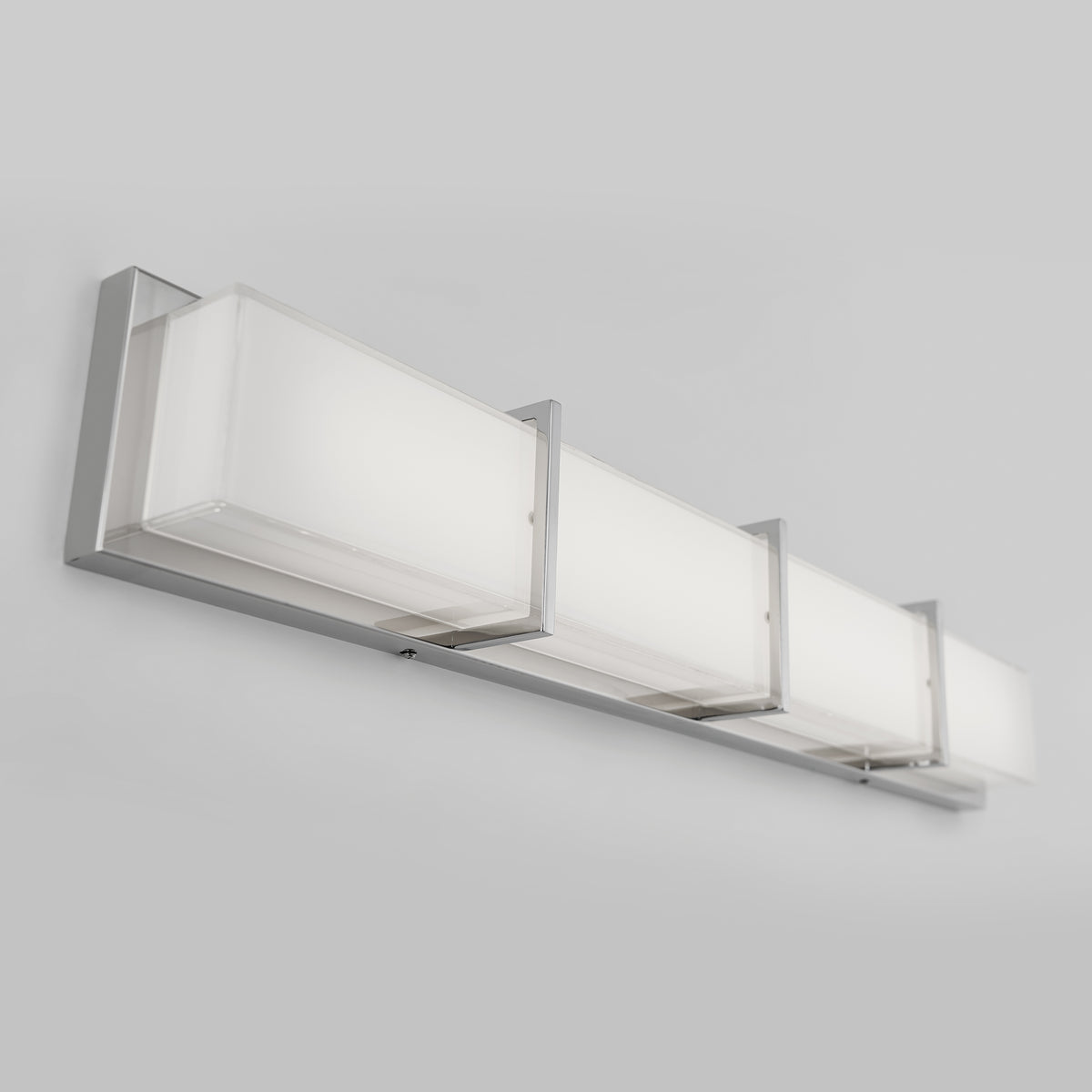 The Artika Subway 35-in (89 cm) Integrated LED Vanity Light Bar features three rectangular frosted glass shades and a sleek brushed nickel base, ideal for your bathroom and shown here against a plain light gray background.