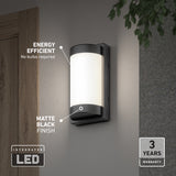 Modern LED outdoor wall light with a matte black finish mounted near a door; labeled as energy efficient (no bulbs required), features integrated LED, and comes with a 3-year warranty.
