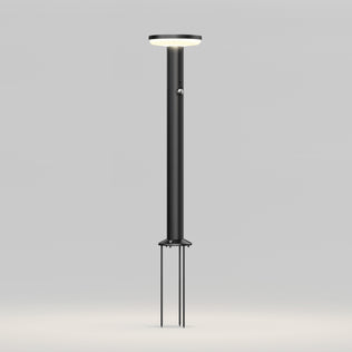The Artika Urbia Solar LED Bollard features a modern black design with a circular top and three stakes for easy ground installation.