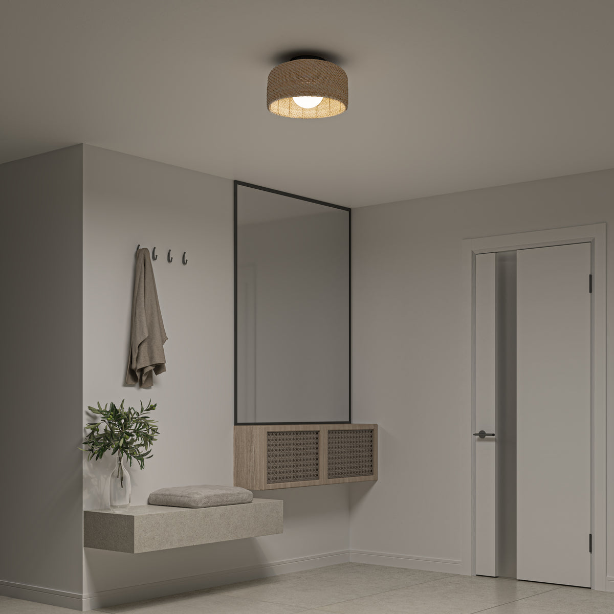 A modern, minimalist entryway features a floating bench with cushion, wall hooks holding a coat, a large mirror, potted plant, and door. The neutral decor is brightened by the Artika Emiko modern LED flush mount light 5 CCT on the ceiling.