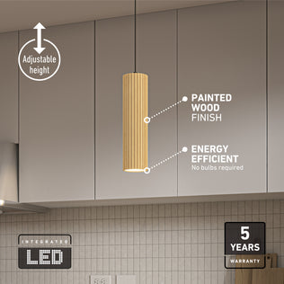 The Artika Groove LED modern pendant light, featuring a cylindrical design and textured wood finish, hangs over a kitchen island. It offers adjustable height, integrated energy-efficient LED (no bulbs needed), 3 CCT, and comes with a 5-year warranty.