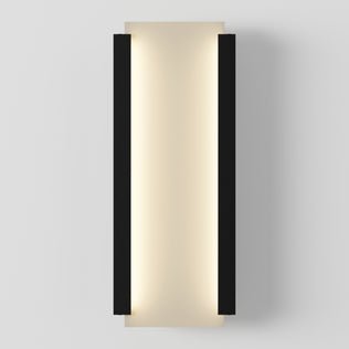 The Artika Blade indoor-outdoor LED wall light features a modern rectangular design with a central frosted panel, emitting soft warm light, framed by two vertical black bars on each side, shown mounted on a white wall.