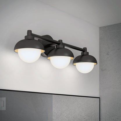 The Artika Boden LED mid-century bathroom vanity light features three round white glass shades and a matte black frame, mounted above a large mirror on a gray wall.