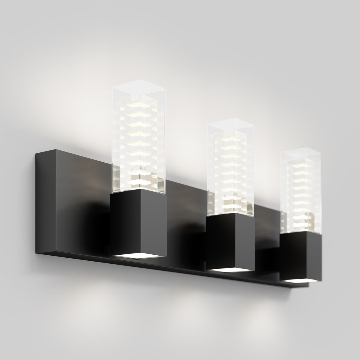 The Artika Hologram LED modern bathroom vanity light 5 CCT features three black bases and clear glass, perfect for mirror lighting.