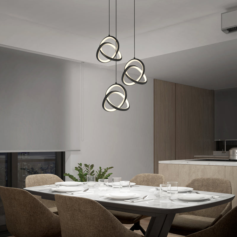 A modern dining room features a marble table for four, brown upholstered chairs, neutral walls, a large window, minimal decor with a plant centerpiece, and the Artika Zephyr 3-light LED pendant illuminating the space above.