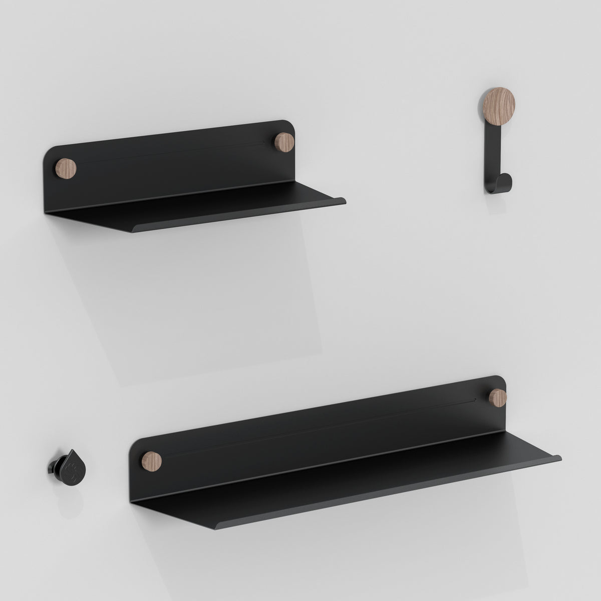 Two black metal wall shelves with wooden accents and two matching hooks are mounted on a white wall, creating a minimalist and modern storage display.