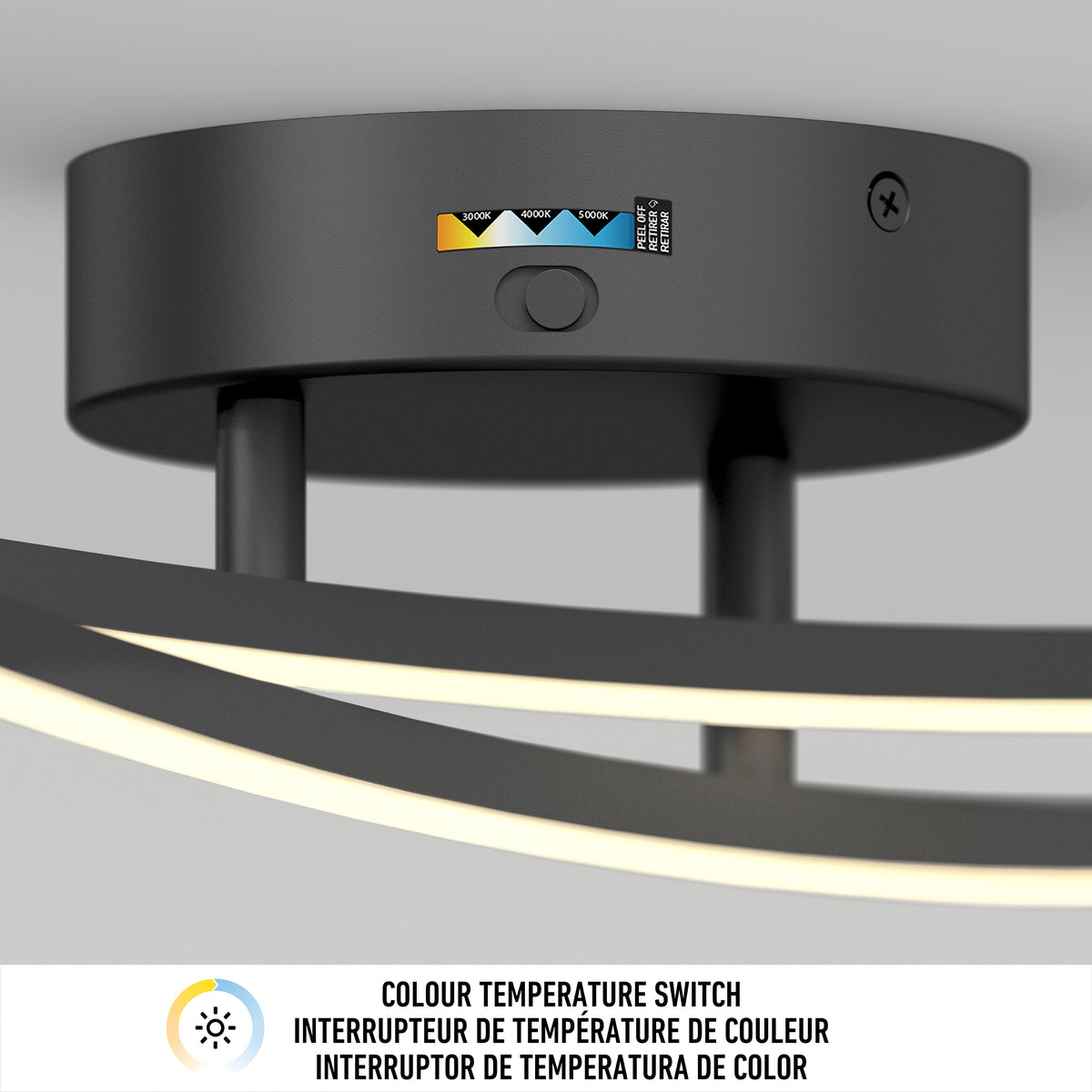 Close-up of a modern black ceiling light fixture with a color temperature switch showing options from warm to cool. Below is a label in English and French, reading COLOUR TEMPERATURE SWITCH.