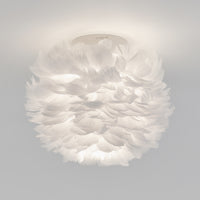 The Artika Plume LED flush mount light features soft white feathers for a fluffy, cloud-like look, making it a unique modern ceiling fixture.