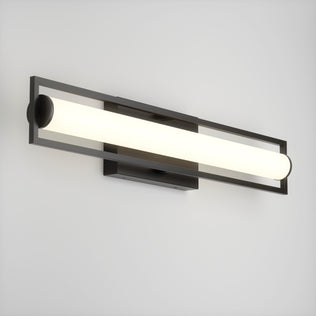 The Rialto modern LED bathroom vanity light 3 CCT by Artika features a dimmable cylindrical white light tube in a sleek rectangular black frame, elegantly mounted on a plain white wall.