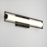 A modern wall-mounted light fixture with a horizontal cylindrical frosted glass shade and a sleek black metal frame, illuminated against a plain white wall.