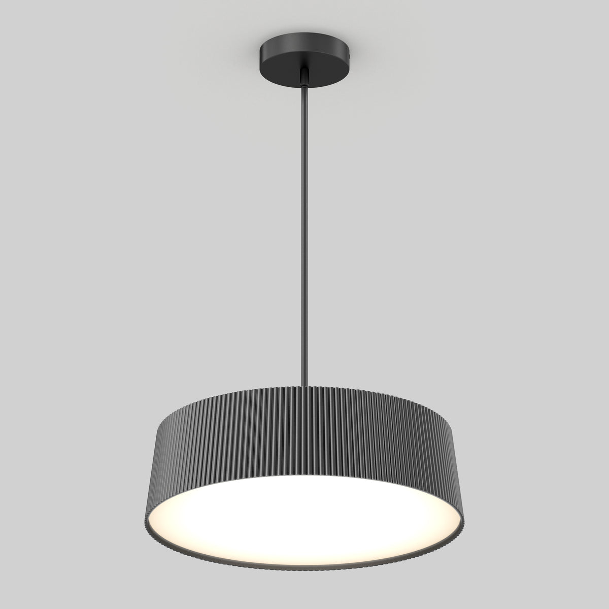 The Artika Groove Drum LED contemporary pendant light features a black, vertically ridged cylindrical shade and hangs from a slim rod, providing a bright, even glow against a plain light gray background.