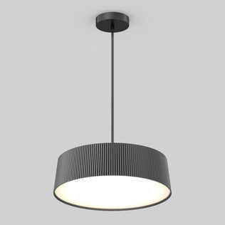 The Artika Groove Drum LED contemporary pendant light features a black, vertically ridged cylindrical shade and hangs from a slim rod, providing a bright, even glow against a plain light gray background.
