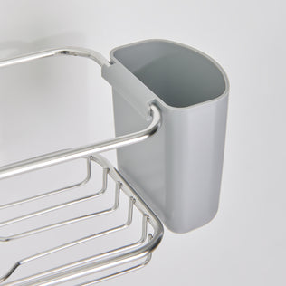 A close-up of the Artika Ulysse hanging Shower Caddy, a gray plastic organizer attached to a metal wire rack, designed for efficient bathroom storage against a white background.