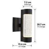 A black wall-mounted outdoor light fixture with a cylindrical, bubble-textured glass shade. Dimensions are labeled: height 28.7 cm (11.3 in), width 15.6 cm (6.1 in), and depth 7.2 cm (2.8 in).