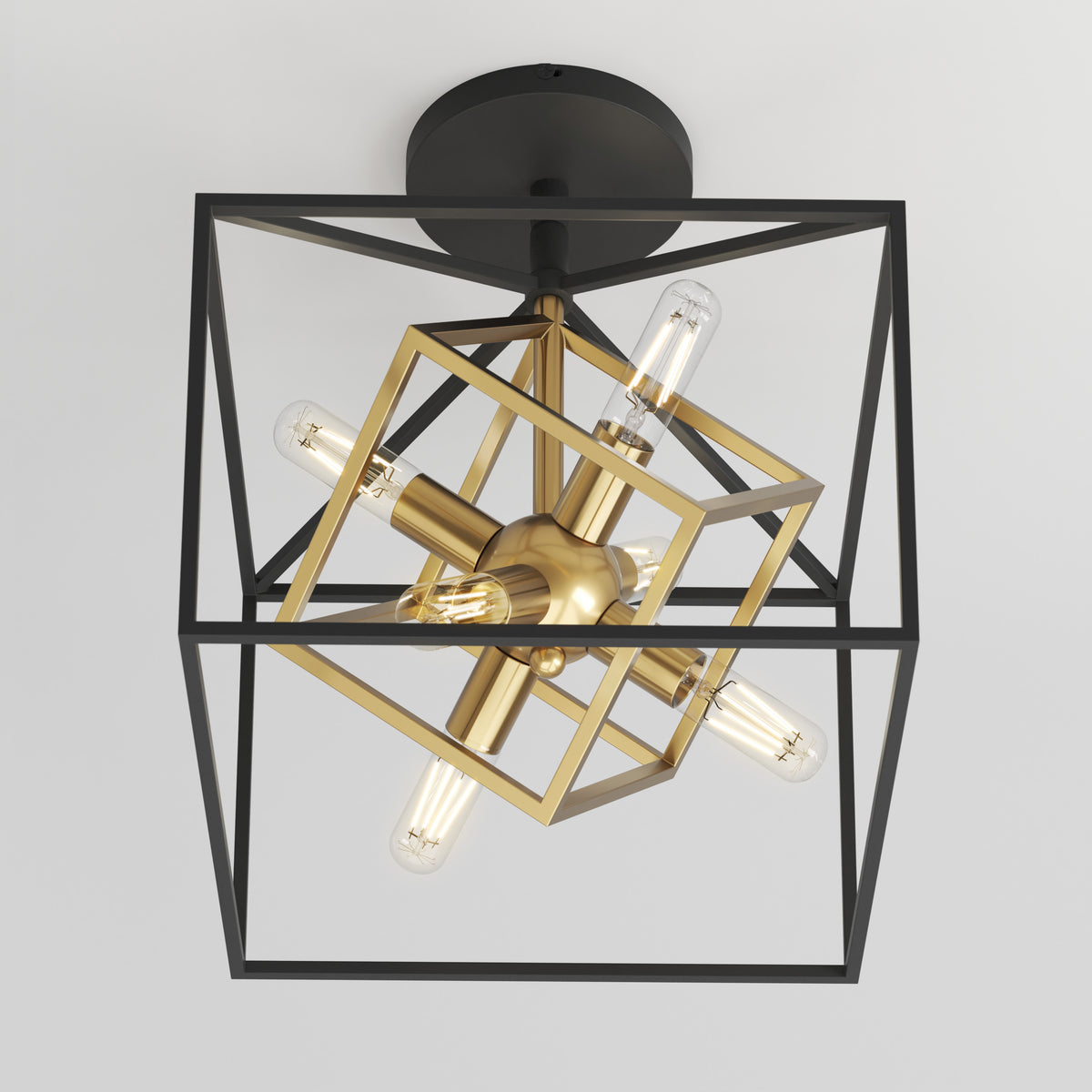 A modern ceiling light fixture with exposed bulbs, featuring intersecting black and gold geometric frames in a cube and starburst design, mounted on a round black base.