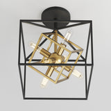 A modern ceiling light fixture with exposed bulbs, featuring intersecting black and gold geometric frames in a cube and starburst design, mounted on a round black base.