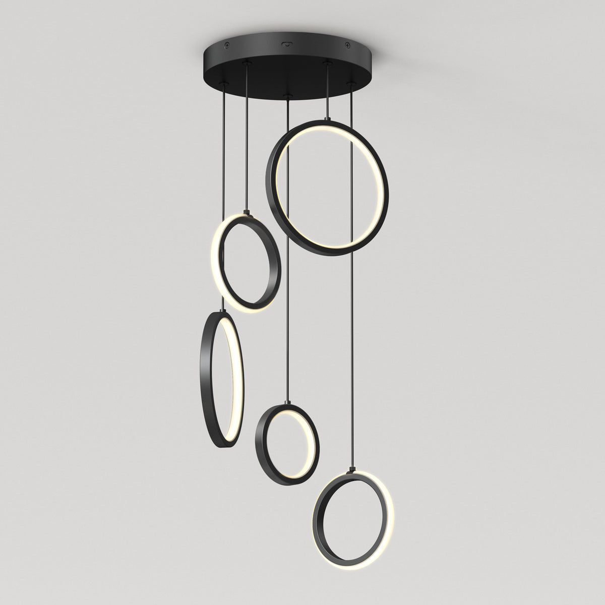 The Artika Elmo 5-light LED pendant features five black rings in varying sizes, each suspended at different heights with built-in LED lights along their inner edges. Adjustable CCT offers versatile modern lighting for any space.